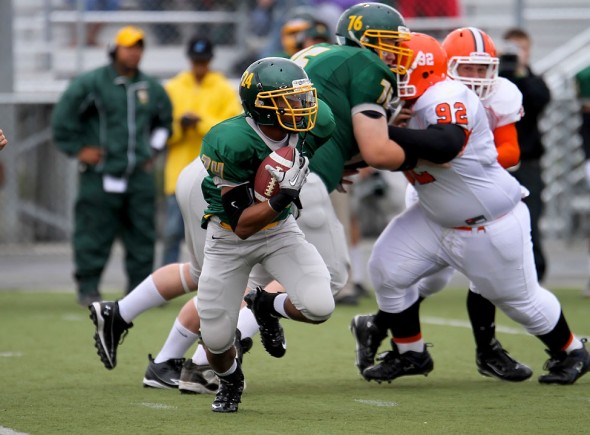 Service Senior Michael McCrae (24) runs the kick-off back.