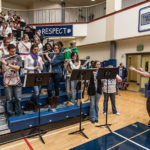 Mr. Poole directs the pep band at a Varsity Basketball game for the last time.