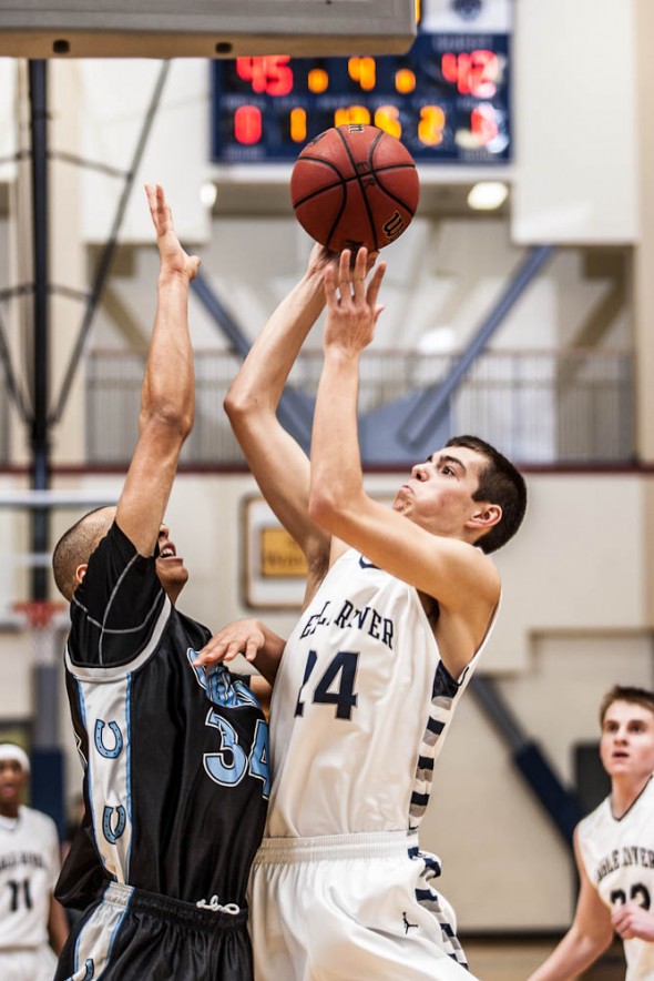 Junior Hunter Hill goes up for two and the foul against Chugiak