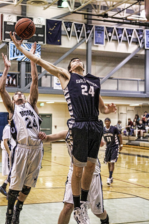 Junior Hunter Hill grabs a rebound in the loss to Chugiak