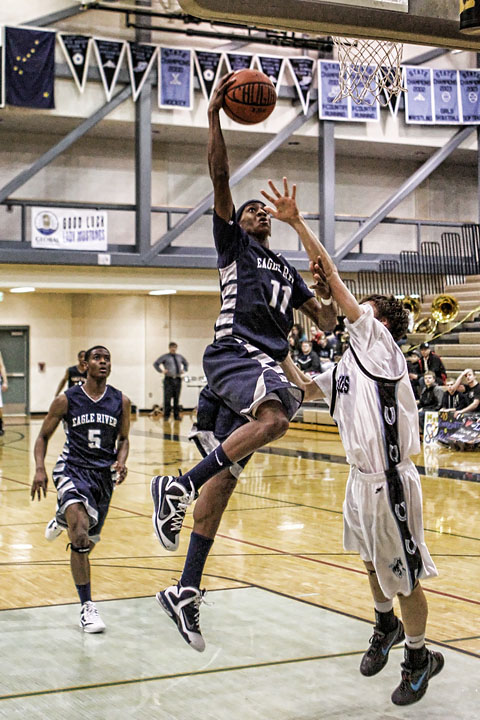 Junior Shaquan Rhoades heads to the hoop for a lay up