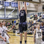 Senior Kevin Waterman heads to the rim for a dunk against Chugiak