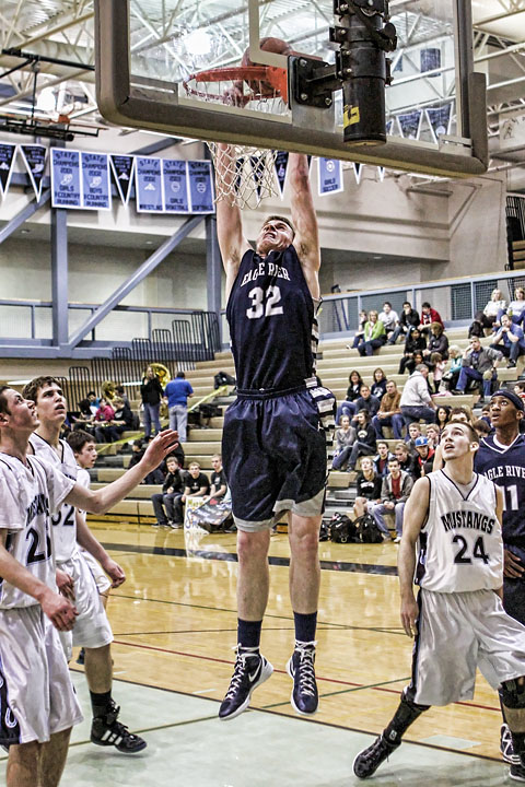 Senior Kevin Waterman heads to the rim for a dunk against Chugiak