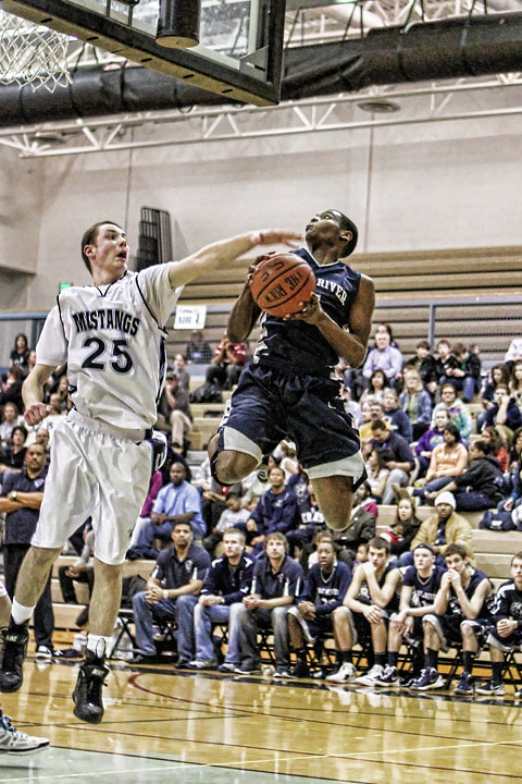 Senior Chris Parker hangs in the air against Chugiak