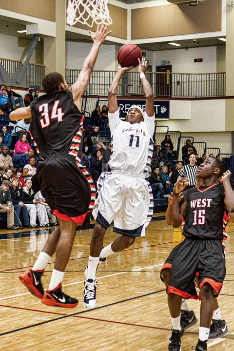 Junior Shaquan Rhoades shoots over the West Defense