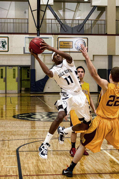 Junior Shaquan Rhoades tries to draw a foul. Rhoades lead the Wolves with 11 points against Diamond