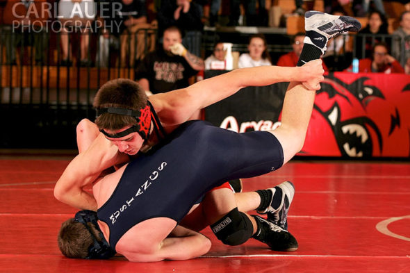 December 12th, 2012: A Arvada wrestler attempts to roll a Mullen wrestler over in their meet at Arvada Senior High School