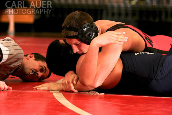 December 12th, 2012: The referee gets a close look at the action as a Arvada wrestler attempts to pin a Mullen wrestler in their meet at Arvada Senior High School