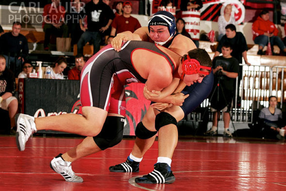 December 12th, 2012: A Arvada wrestler attempts a takedown on a Mullen wrestler in their meet at Arvada Senior High School