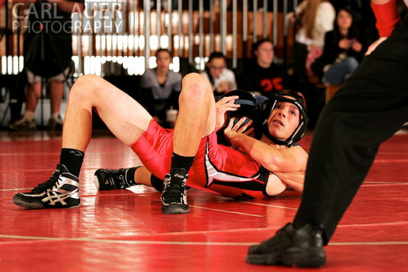 December 12th, 2012: A Arvada wrestler looks up at the referee as a Mullen wrestler attempts a pin in their meet at Arvada Senior High School