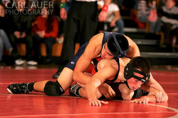 December 12th, 2012: A Arvada wrestler attempts to get away from a hold by a Mullen wrestler in their meet at Arvada Senior High School