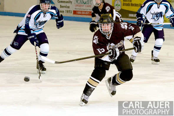 January 11th, 2013: A Battle Mountain player flips the puck ahead of him in the game at the Apex Ice Arena against Ralston Valley on Friday night in Arvada, CO