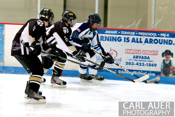 January 11th, 2013: A Ralston Valley player beats two Battle Mountain players to the puck in their game at the Apex Ice Arena on Friday night in Arvada, CO