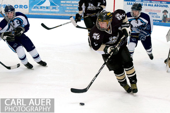 January 11th, 2013: A Battle Mountain player tries to clear the puck from in front of his goal in the game at the Apex Ice Arena against Ralston Valley on Friday night in Arvada, CO