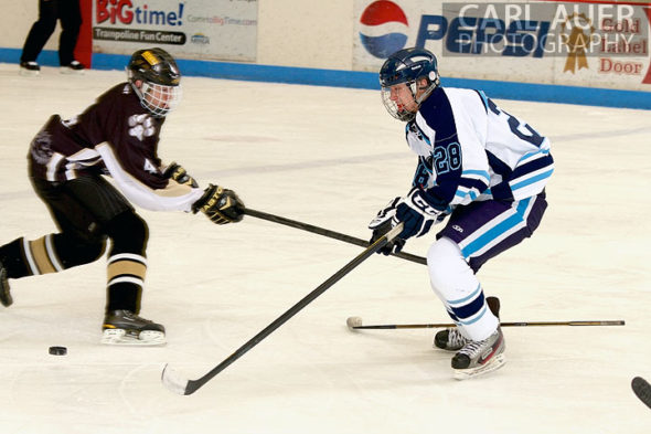 January 11th, 2013: A Battle Mountain player and Ralston Valley player fight for the puck in their game at the Apex Ice Arena against Ralston Valley on Friday night in Arvada, CO