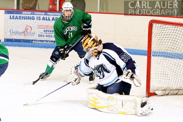 February 6th, 2013: Standley Lake Gators forward Kint Thede (21) watches as Ralston Valley Mustang goalie Zach Larocque (31) in their game at the Apex Ice Arena in Arvada, Colorado