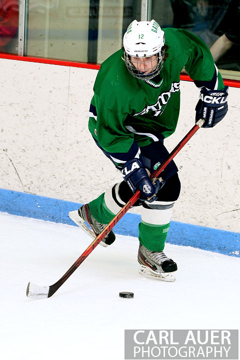 February 6th, 2013: Standley Lake Gators defender Chris Huitt (12) picks up the puck behind the goal in the game against the Ralston Valley Mustangs at the Apex Ice Arena in Arvada, Colorado