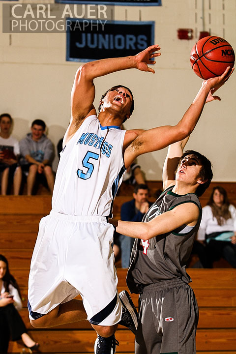 February 27th 2013: Arvada, Colorado - Ralston Valley Mustang junior Zac Stevens (5) makes a baseline shot attempt past Smoky Hill's Connor Mooney in the game at Ralston Valley High School.