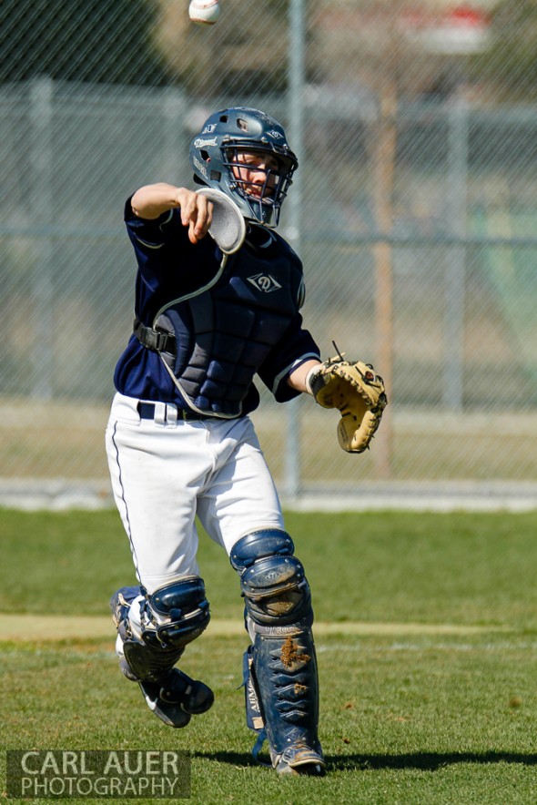 April 26th, 2013: The Columbine Rebel's catcher throws out a runner at first base in the away game against the Arvada West Wildcats at Arvada West High School in Arvada, Colorado