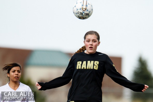 April 25th, 2013: A Green Mountain Ram player jumps into the air to head the ball in the game against the Arvada Bulldogs at the North Area Athletic Complex in Arvada, Colorado