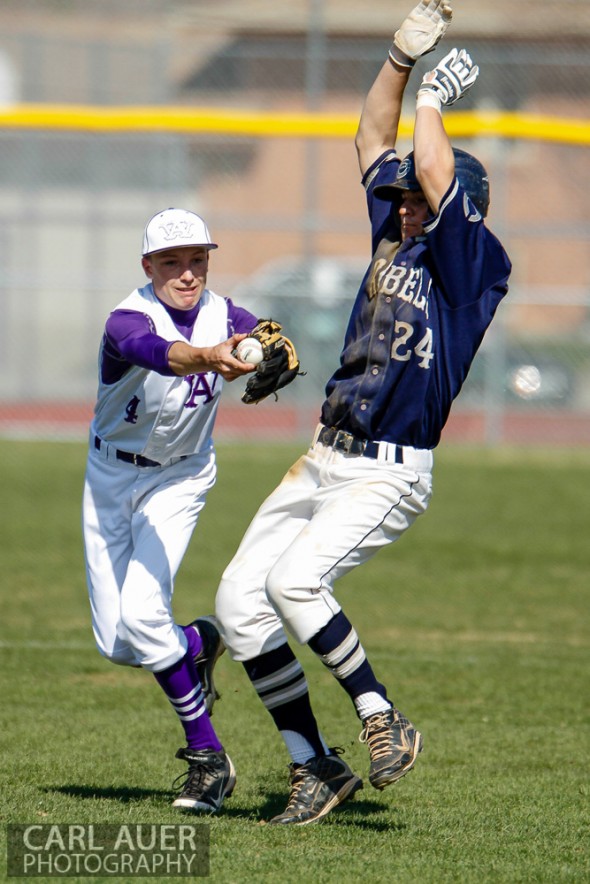 April 26th, 2013: Columbine Rebels baserunner Austin Anderson (24) avoids the tag by Arvada West Wildcat's shortstop Ethan Fleming (4) in the league game at Arvada West High School in Arvada, Colorado