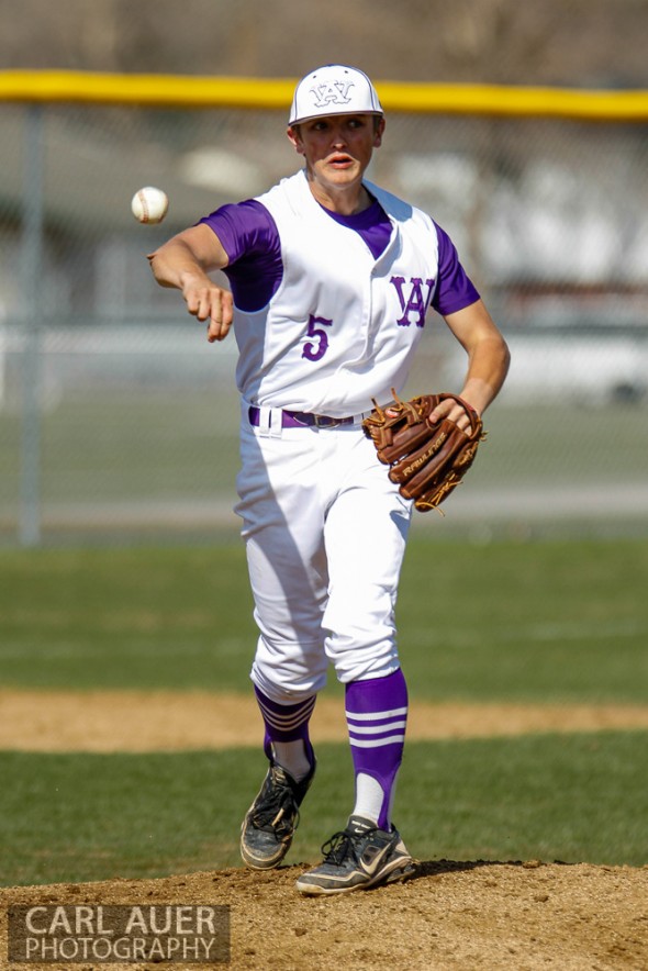 April 26th, 2013: Arvada West Wildcat pitcher Justin Mulvaney (5) attempts to pick a runner off at first base in the game against the Columbine Rebels at Arvada West High School in Arvada, Colorado