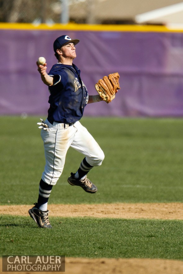April 26th, 2013: Columbine Rebels shortstop Austin Anderson (24) attempts to throw out a Arvada West Wildcat batter at first base in the league game at Arvada West High School in Arvada, Colorado