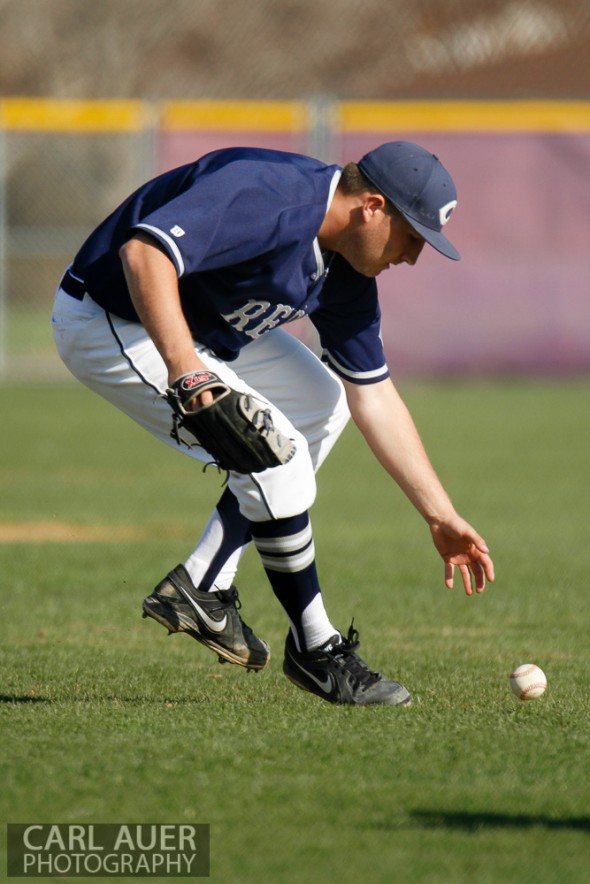 April 26th, 2013: Columbine Rebels pitcher Kyle Lopez (12) bare hands a ground ball in the league game against the Arvada West High School Wildcats in Arvada, Colorado