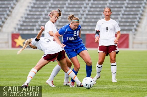 May 22, 2013 - A Broomfield Eagles player attempts to maintain control of the ball as she is surrounded by Cheyenne Mountain Indians in the CHSAA 4A Girls Soccer Championship Game at Dick's Sporting Goods Park in Commerce City, Colorado