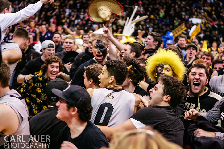 February 14, 2013 - Colorado Buffaloes guard Askia Booker (0) is mobbed as the Colorado Student Section rushes the floor after defeating top 10 Arizona in Boulder, Colorado at the Coors Events Center