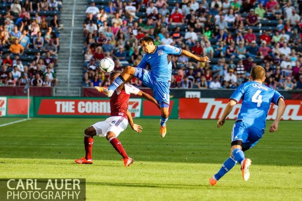 June 15th, 2013 - San Jose Earthquake defender Steven Beitashour (33) goes airborne to kick the ball away from Colorado Rapids defender/midfielder Anthony Wallace (6) during the first half of action in the MLS match between San Jose Earthquake and the Colorado Rapids at Dick's Sporting Goods Park in Commerce City, CO