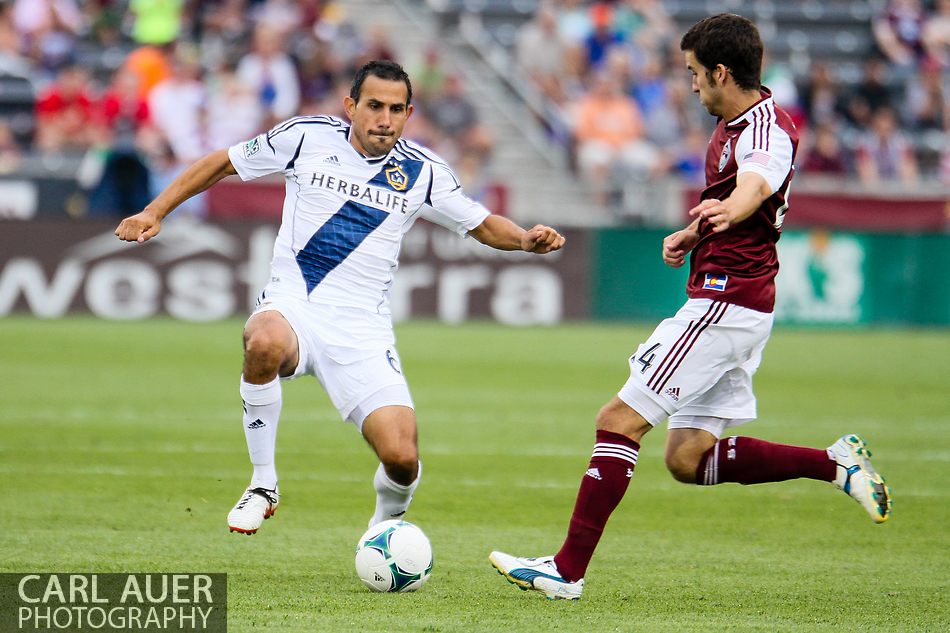 July 27th, 2013 - Former Colorado Rapids captain and current LA Galaxy midfielder Pablo Mastroeni (6) attempts to bring the ball past Colorado Rapids midfielder Nathan Sturgis (24) in the second half of the Major League Soccer match between the LA Galaxy and the Colorado Rapids at Dick's Sporting Goods Park in Commerce City, CO