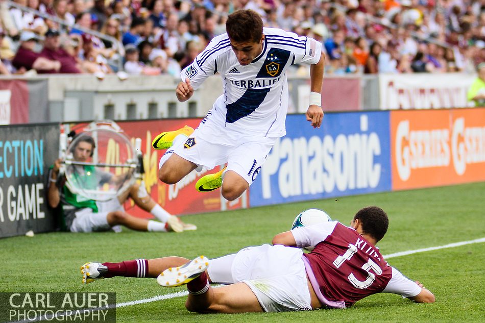 July 27th, 2013 - LA Galaxy midfielder Hector Jimenez (16) jumps over Colorado Rapids defender Chris Klute (15) to avoid the slide tackle in the second half of the Major League Soccer match between the LA Galaxy and the Colorado Rapids at Dick's Sporting Goods Park in Commerce City, CO