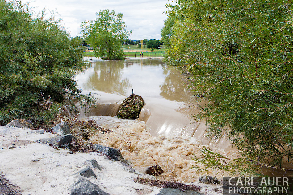 September 13, 2013: A small creek in on Alkire Street in Arvada, CO that is fed by Leyden Lake overflows into yards near the Youth Memorial Sports Complex after record breaking rains hit Colorado over the last few days (Carl Auer)